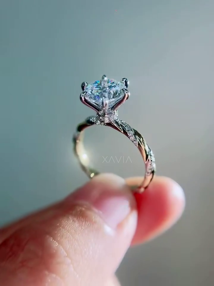 macro close up of round brilliant lab grown diamond solitaire engagement ring displaying crisp facets and six prong cathedral mount