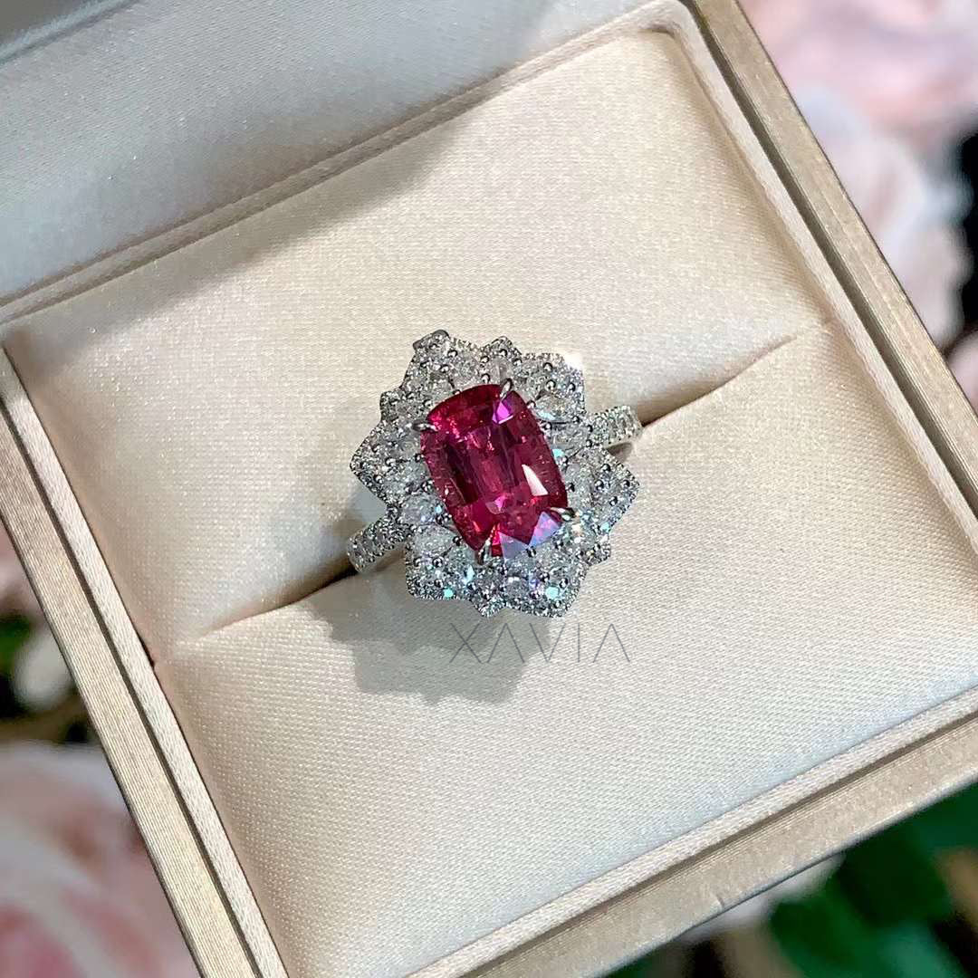 Front view of cushion ruby ring with diamond floral halo and pavé band in white gold