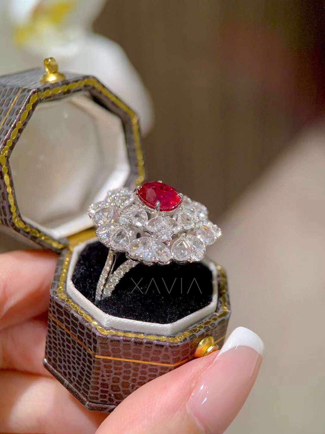 Side angle of statement ruby center floral halo diamond ring showing elevated cluster design and pavé diamond band craftsmanship