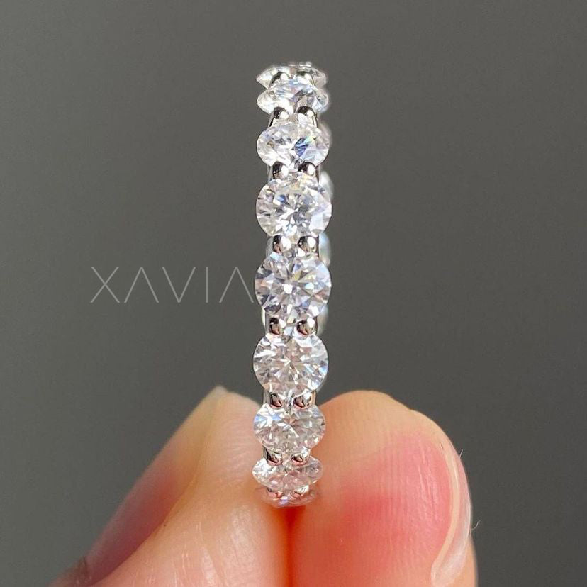 Side profile of shared prong eternity band, showcasing low-set brilliance and stackable round diamond layout.