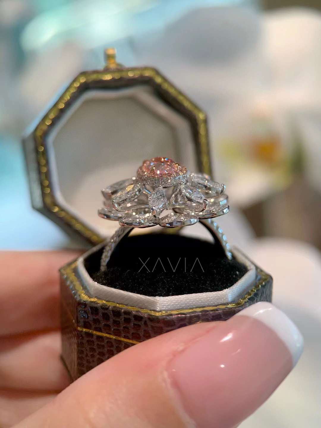 layered side angle view of sculptural floral halo diamond ring with pink center