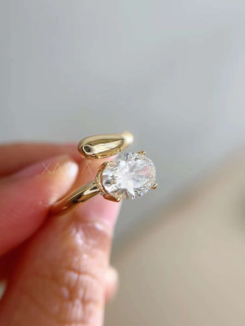 side view of oval cut lab diamond open wrap solitaire ring in polished yellow gold showcasing curved band design