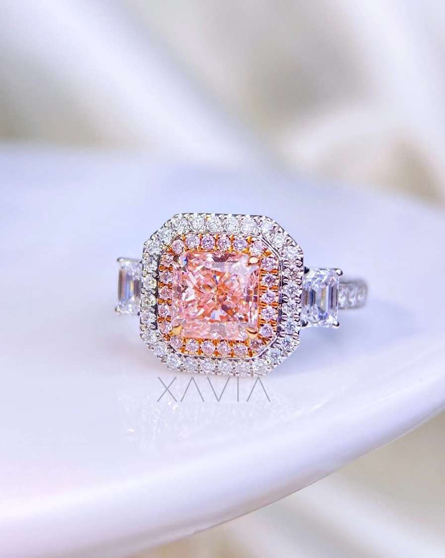 side angle of pink radiant diamond halo ring with tapered baguette sides