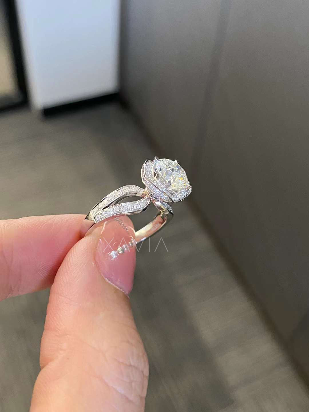 side angle view of round halo lab diamond ring with split shank pavé band in white gold