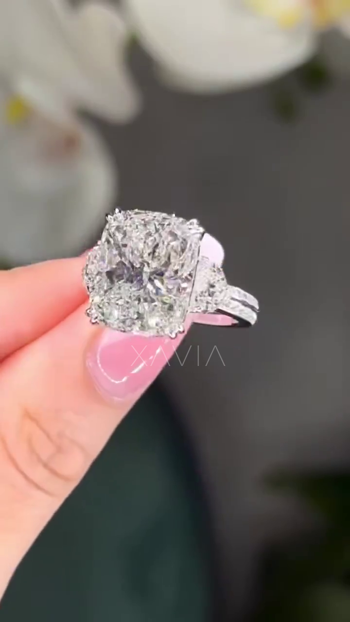 side profile view of cushion cut lab diamond ring with trapezoid side stones and pavé band in platinum setting