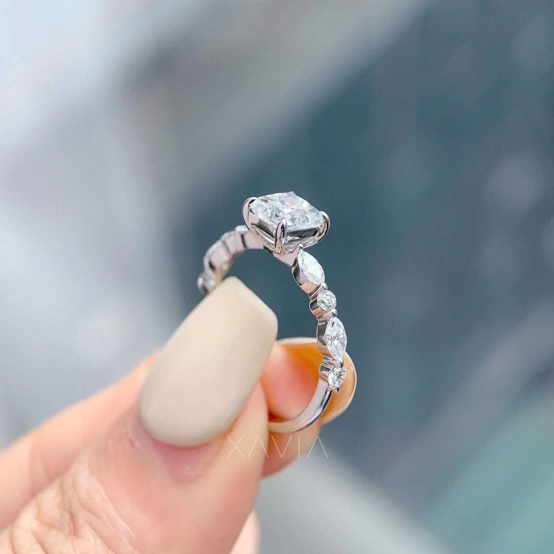 side profile of engagement ring showing marquise and round diamonds