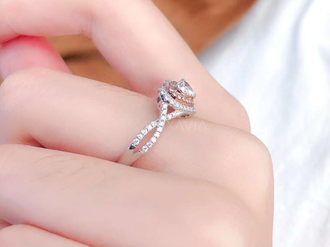 side view of heart shaped diamond ring showing twisted pavé band and raised double halo setting