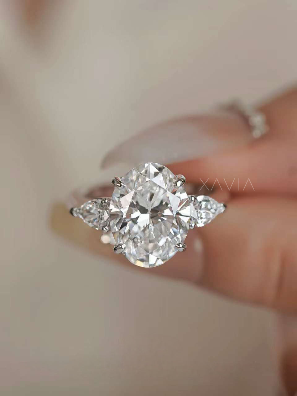 Side profile of oval cut lab grown diamond three stone ring showing elevated basket setting and tapered band structure