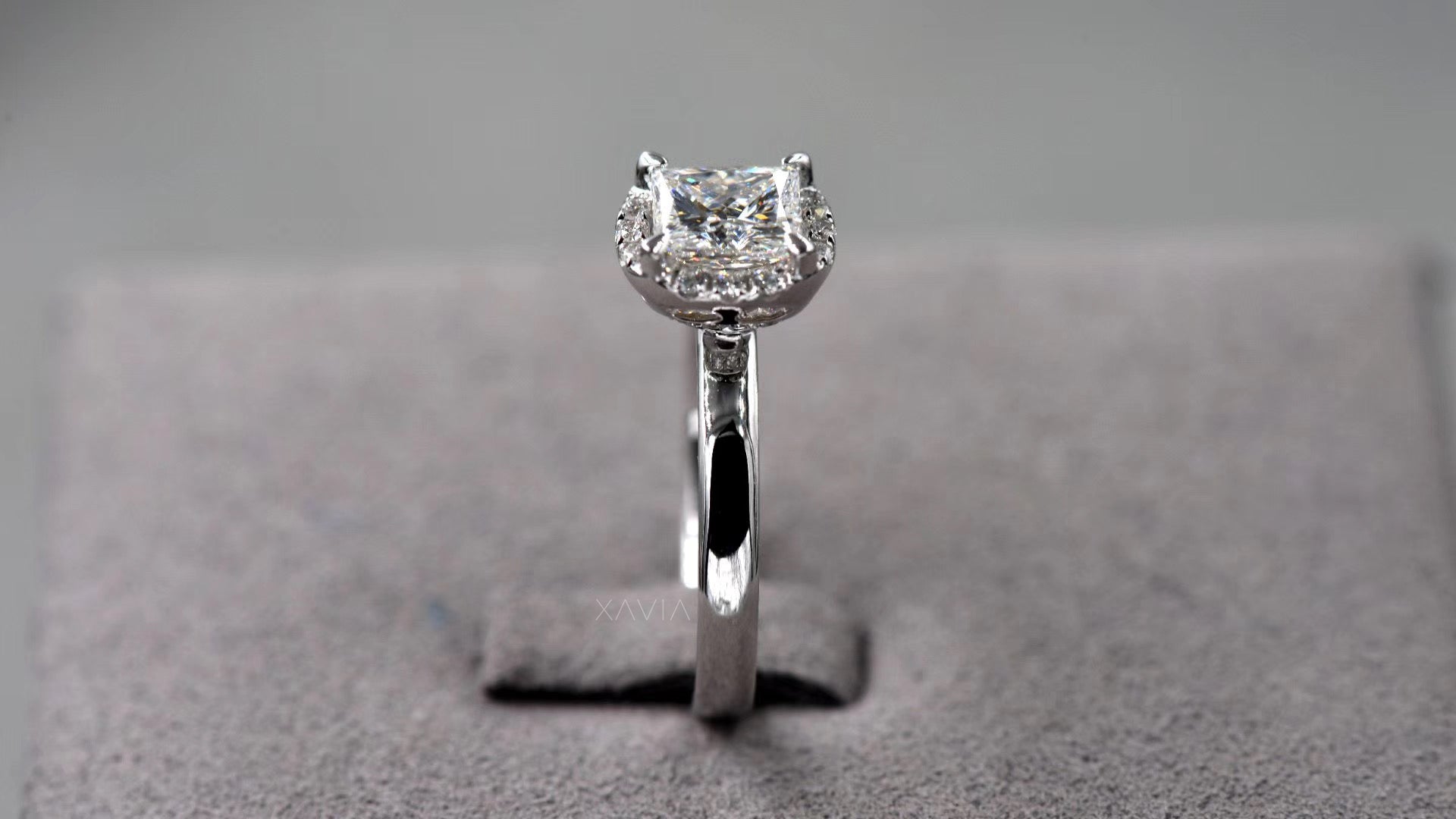side profile of princess cut lab grown diamond engagement ring showing elevated crescent pavé halo setting and minimalist polished band design