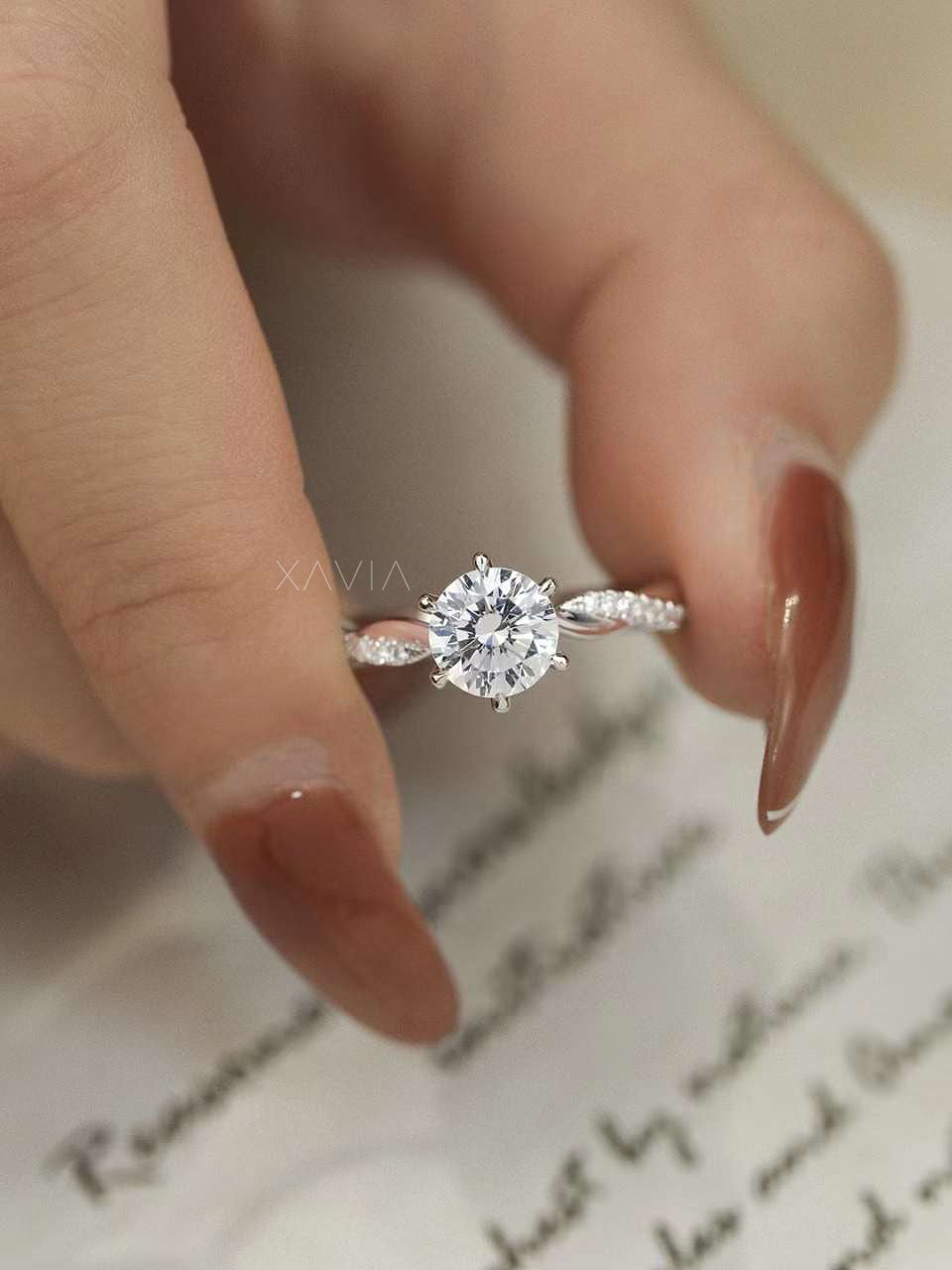 Side profile of solitaire engagement ring showcasing round cut lab-grown diamond and twisted pavé band