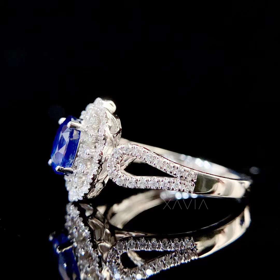 side profile view of oval sapphire halo engagement ring showing pavé split shank diamond band and elevated halo setting craftsmanship