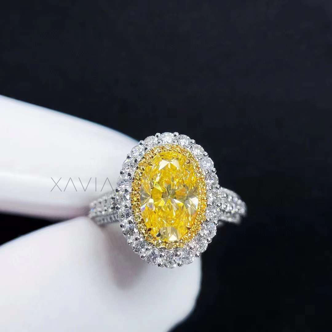 side profile view of oval fancy vivid yellow diamond ring with double halo and pavé shank in platinum
