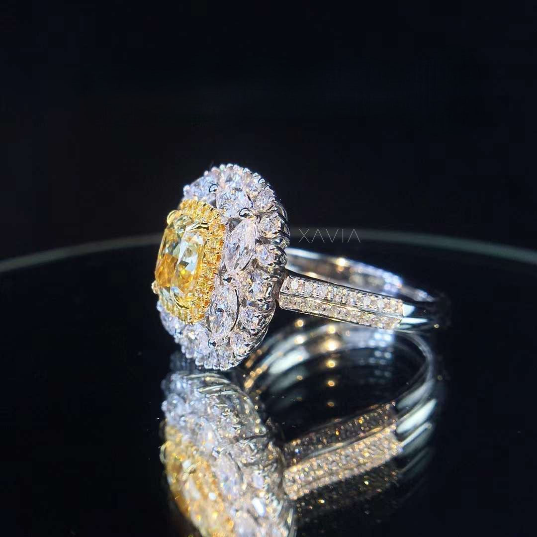 Side profile of fancy yellow cushion lab grown diamond ring highlighting marquise floral halo structure and pavé diamond shank