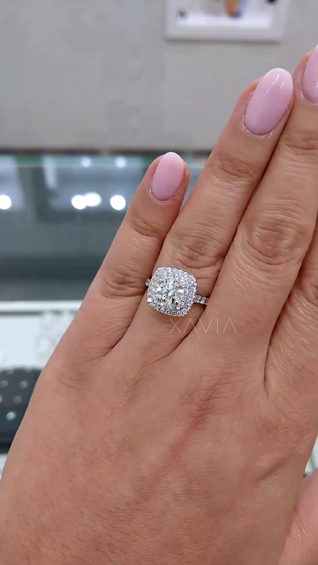 detailed sparkle view of round center diamond with double halo cushion setting designed for maximum brilliance and fire