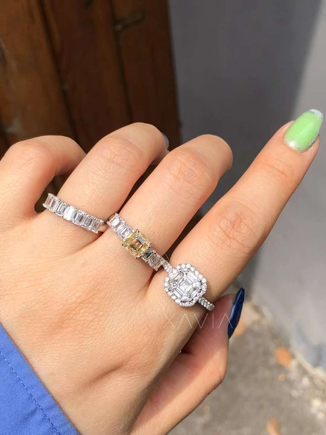 comparison image showing asscher halo engagement ring styled with other diamond bands highlighting size and visual proportion on hand