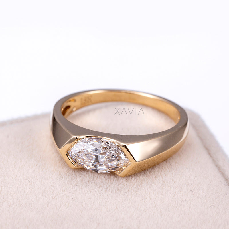 top view of marquise cut lab-grown diamond engagement ring in yellow gold bezel with modern minimalist design