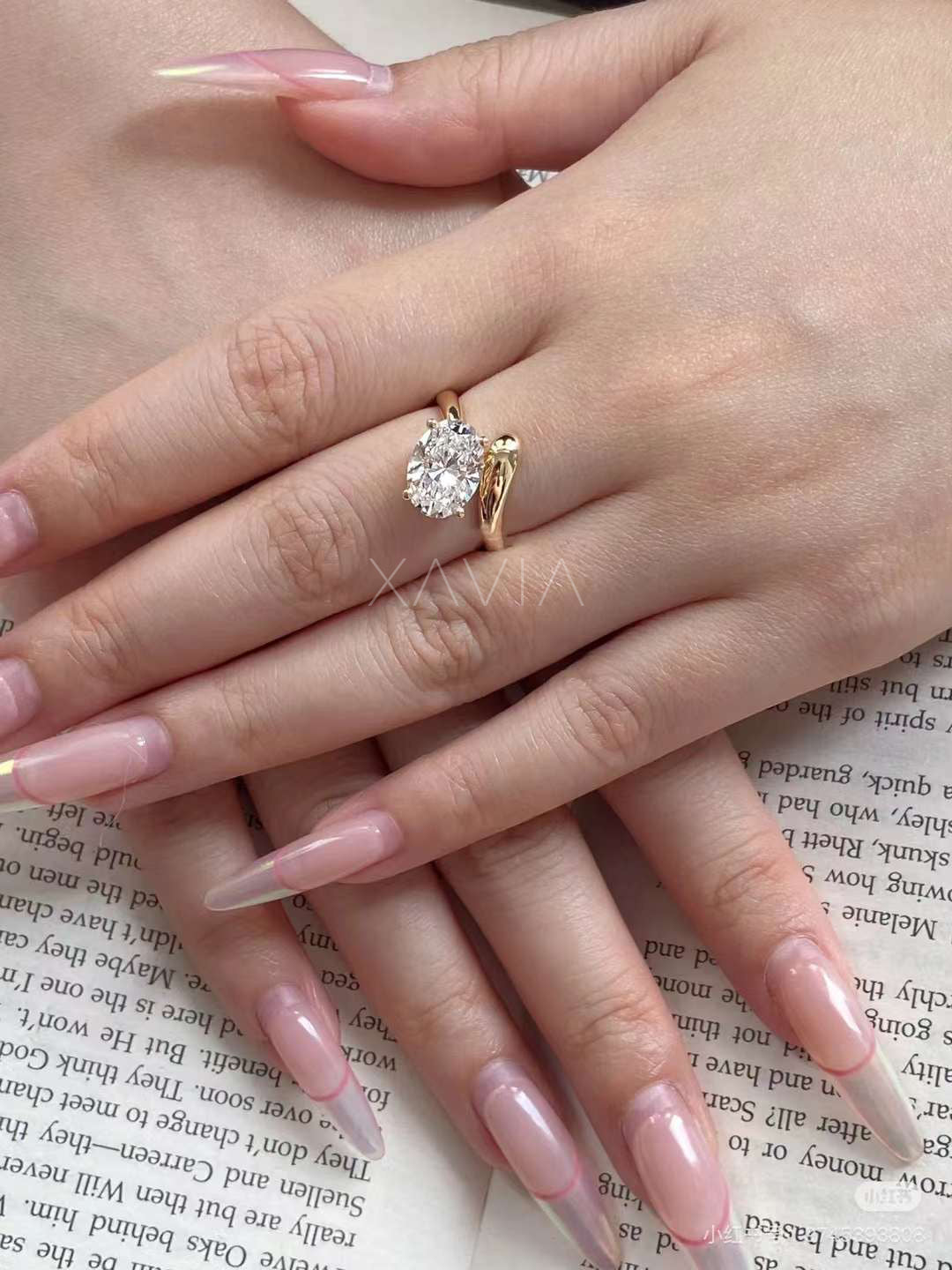 top view of oval cut lab diamond minimalist open wrap solitaire ring in yellow gold highlighting diamond brilliance and band curvature