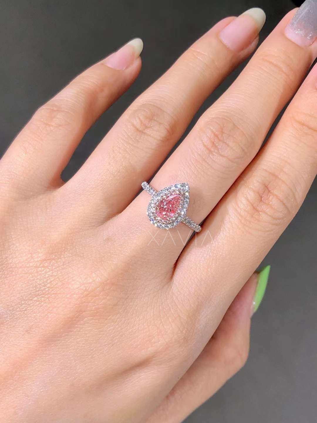 top shot of pear-shaped pink diamond engagement ring in double halo