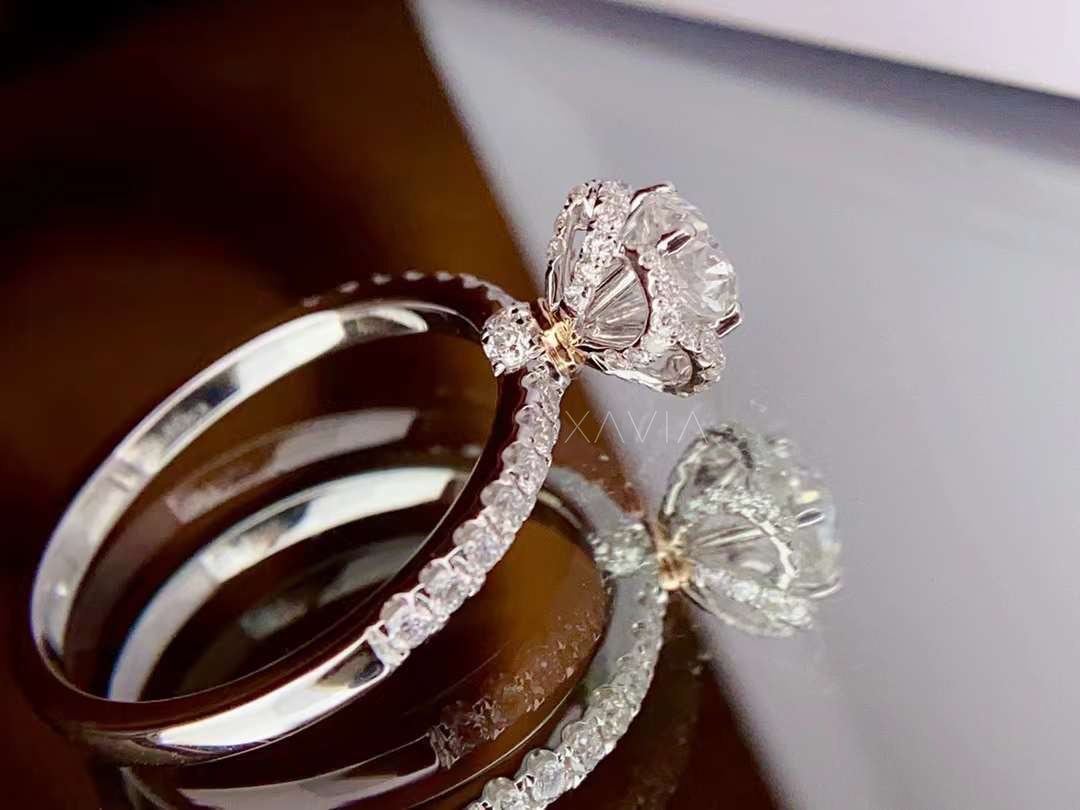 top angle of round cut diamond floral halo engagement ring with pavé accents on slim band