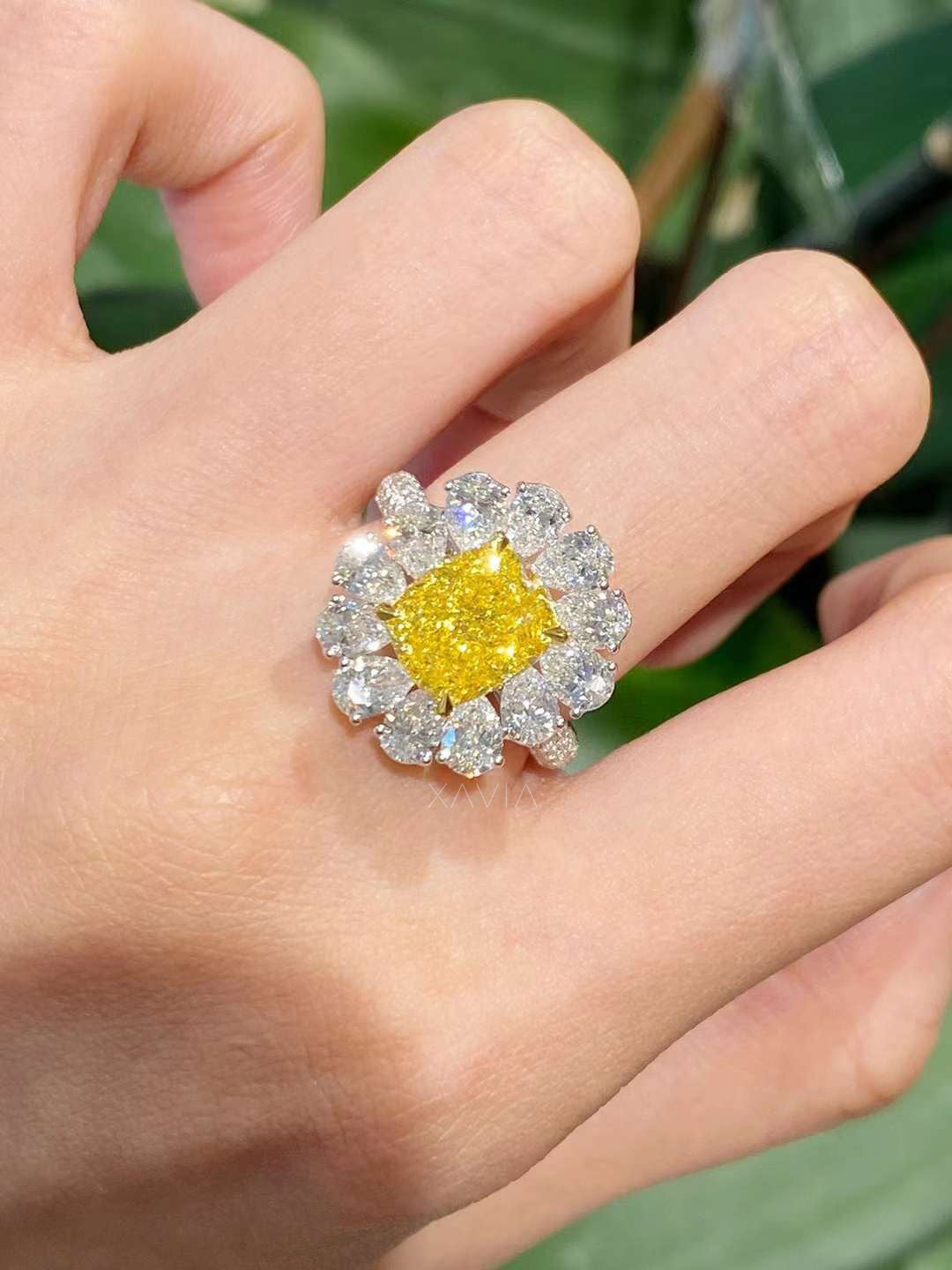 Top view of luxury cushion yellow diamond ring displaying symmetrical marquise floral halo, high sparkle lab grown diamonds, and refined gold design