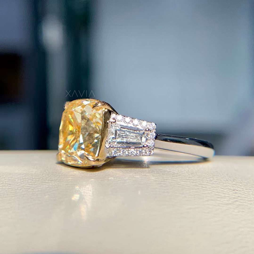 angled view of cushion cut yellow diamond ring with two-tone band