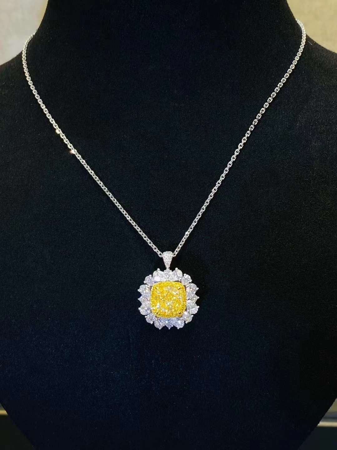 Elegant necklace featuring Velouria cushion fancy yellow diamond pendant surrounded by pear-cut white diamonds on fine chain