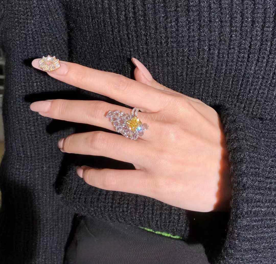 Side perspective of luxury floral cluster ring with fancy yellow cushion cut center diamond surrounded by marquise and pear lab diamonds and pavé split shank