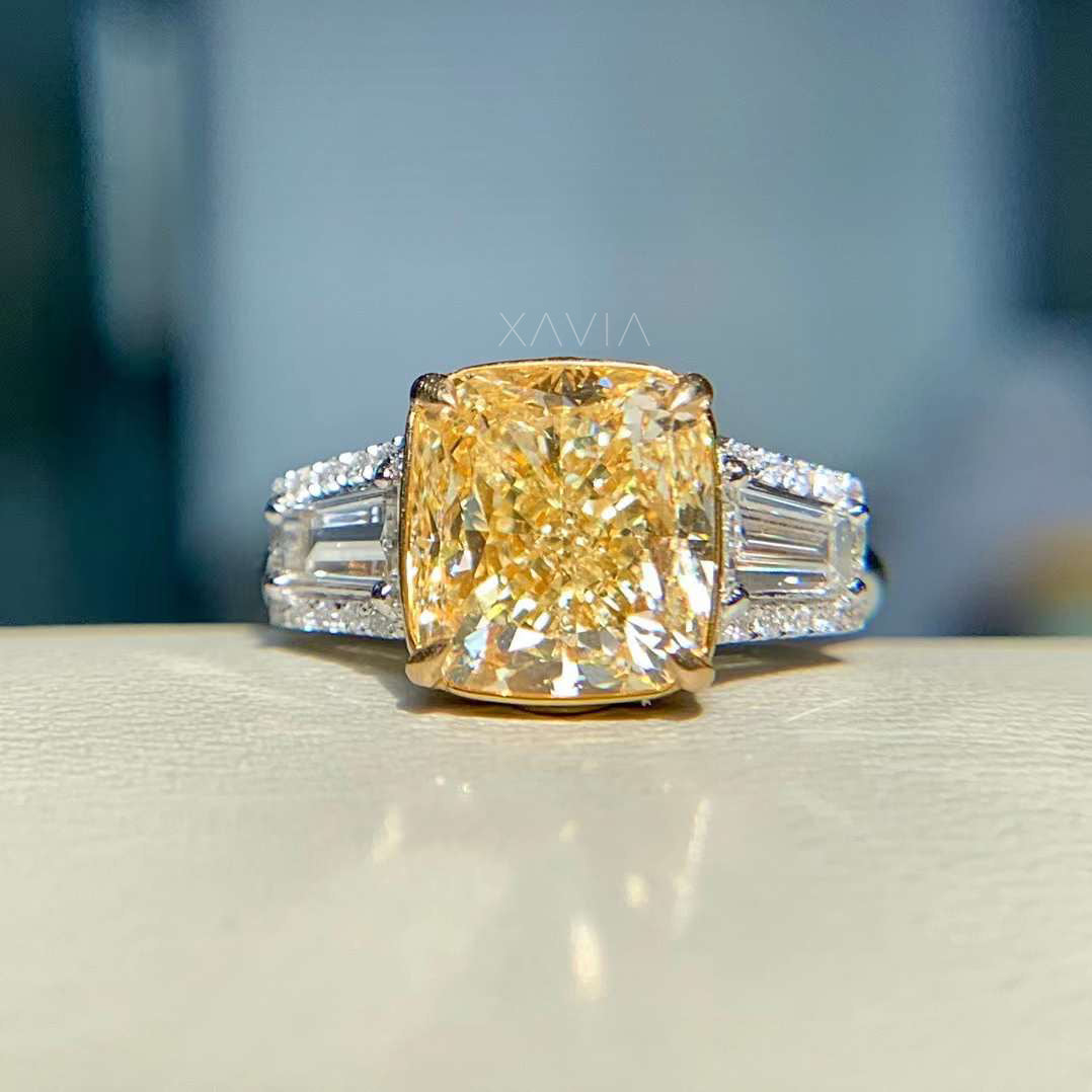 front angle of fancy yellow cushion cut diamond ring with baguette sides
