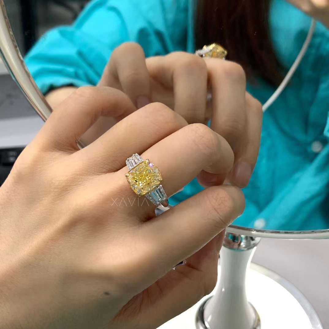 yellow cushion diamond engagement ring worn on hand