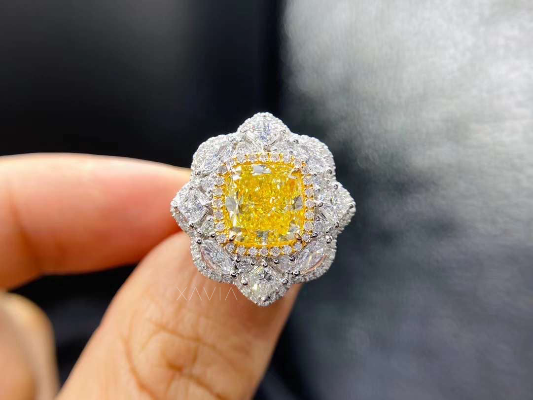 Side profile of cushion yellow diamond ring with marquise floral halo, elevated setting and split shoulders highlighting artisan hand-set details