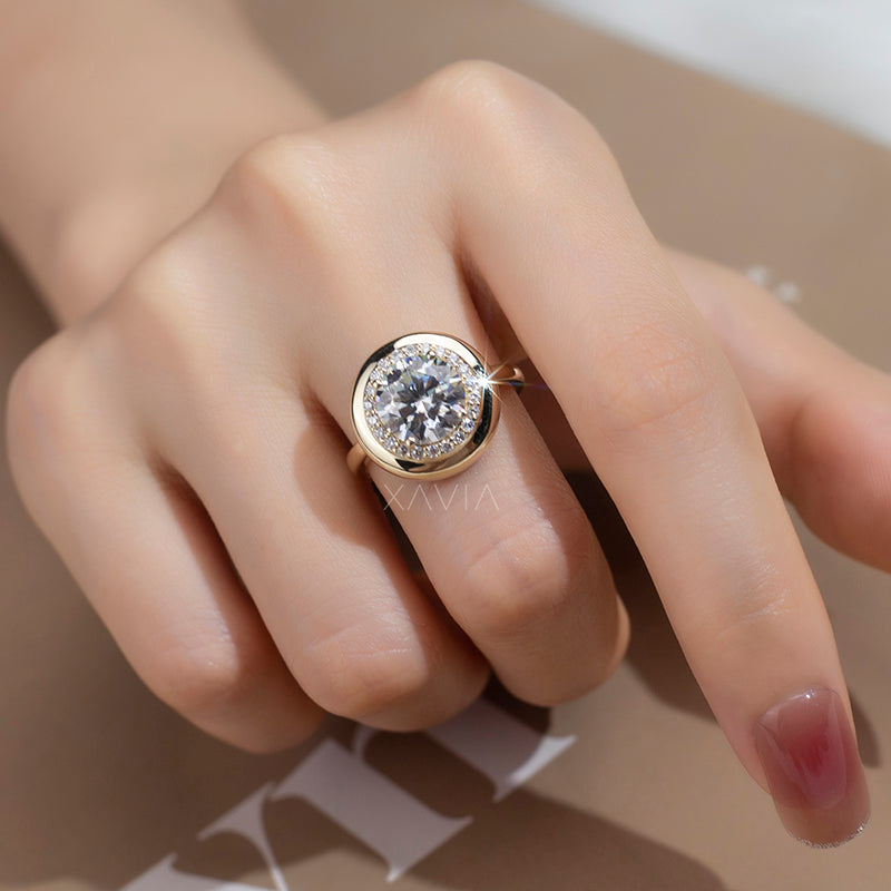 model wearing round brilliant lab diamond bezel halo ring in yellow gold with pavé accents, high-polish finish